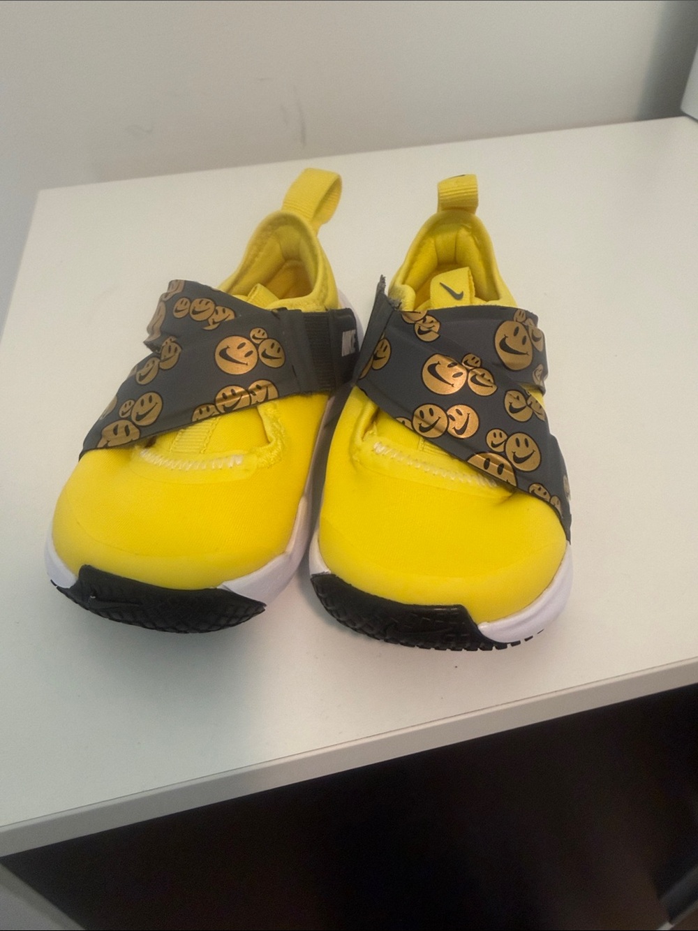 Nike Kids Yellow Slip-On Sneakers with Black Smiley Strap
